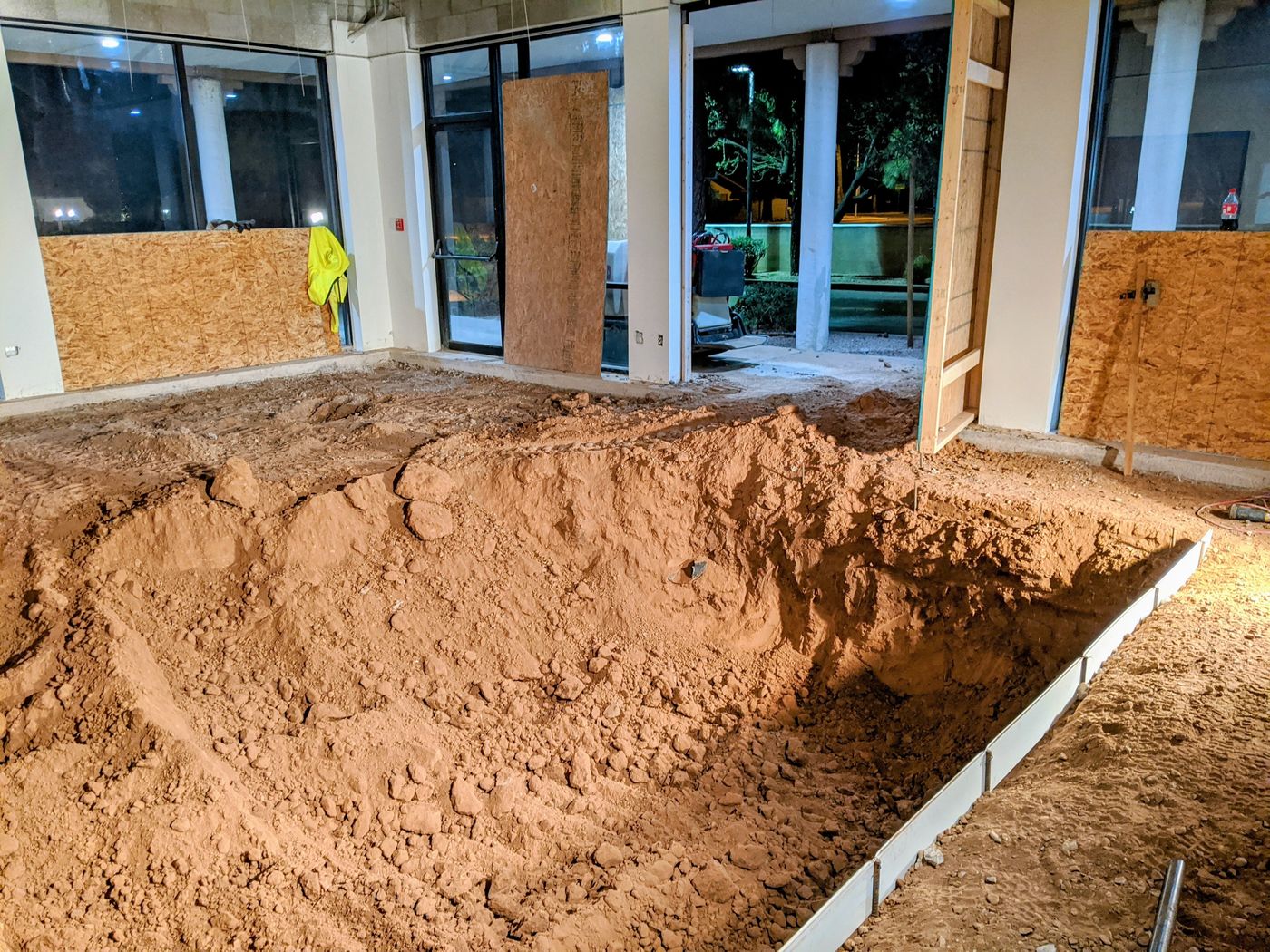 Pool excavation in the floor of an existing building during construction